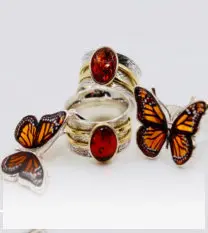 Ring with butterflies and a red center